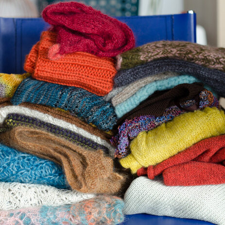 Stack of finished knitted and crocheted samples used in the Stitching Experiments Project.